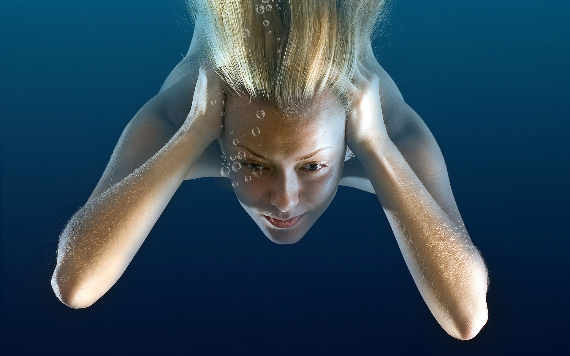 Girl Under Water Immersing Blonde Bubbles