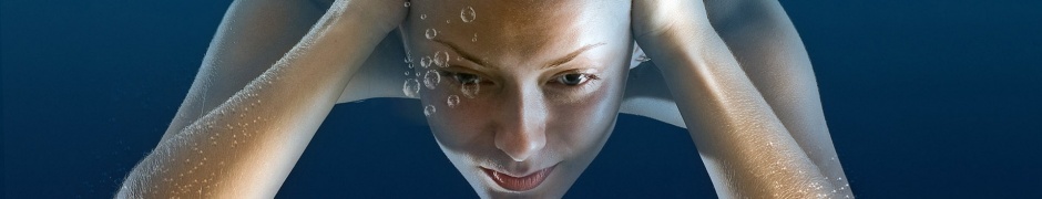 Girl Under Water Immersing Blonde Bubbles