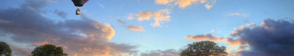 Hot Air Balloons Flying Over Land